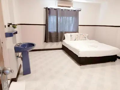 a small room with a bed and a sink at XX Mitr Inn Phuket Old Town -มิตร อินน์ ภูเก็ตโอลทาวน์ in Phuket Town