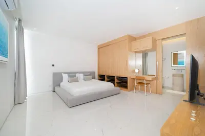 a bedroom with a bed and a desk and a television at Brand New & Modern Luxury 4BR Pool Villa in Residence Lux Pride 2 V12 in Bang Tao Beach