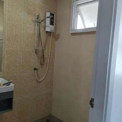 a bathroom with a shower with a sink and a window at The first house 11126 in Ban Phlu Yai