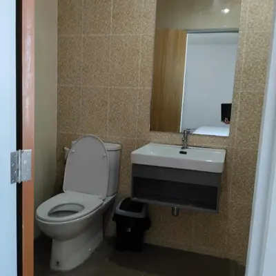 a bathroom with a toilet and a sink and a mirror at The first house 11126 in Ban Phlu Yai