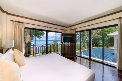a bedroom with a bed and a balcony with a pool at Pool Villa Ao Pro in Ban Ao Kung