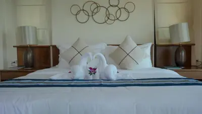 a bed with two stuffed animals on top of it at Pool Villa Ao Pro in Ban Ao Kung