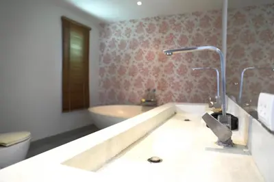 a bathroom with a tub and a sink and a toilet at Villa Kirana in Rawai Beach