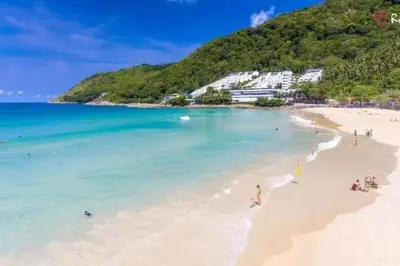 a view of a beach with people in the water at Villa Kirana in Rawai Beach