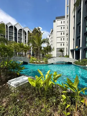 a swimming pool in the middle of some buildings at The Title Halo1 2Bedroom Apartment Naiyang beach in Nai Yang Beach