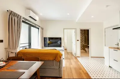 a bedroom with a bed and a living room at The Title Halo1 2Bedroom Apartment Naiyang beach in Nai Yang Beach