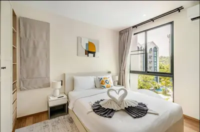a bedroom with a bed with a heart decoration on it at The Title Halo1 2Bedroom Apartment Naiyang beach in Nai Yang Beach