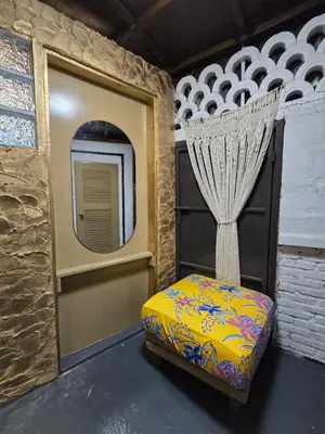 a room with a bed and a window and a mirror at Little Home in Town in Ban Lo Long