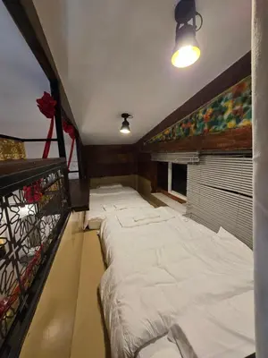 a room with a large bed in a room at Little Home in Town in Ban Lo Long