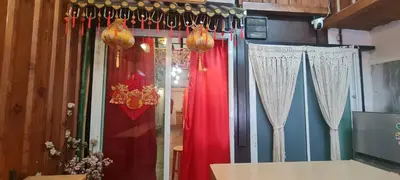 a store window with red curtains and chandeliers at Little Home in Town in Ban Lo Long