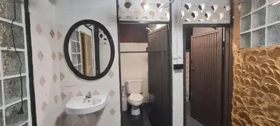 a bathroom with a sink and a mirror and a toilet at Little Home in Town in Ban Lo Long