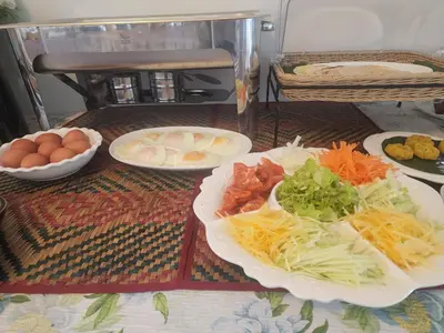 a table with plates of food and eggs on it at Esmeralda View Resort - SHA Extra Plus in Ko Yao Yai