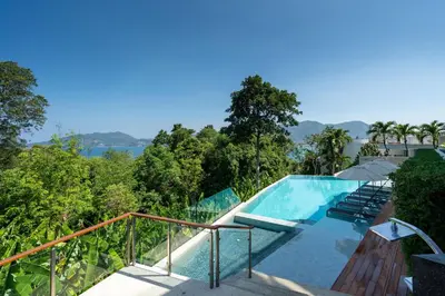 a swimming pool with a view of the trees at Sapphire Bay Luxury Condominiums Patong, 811 in Patong Beach