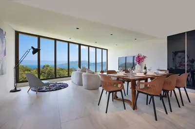 a dining room with a table and chairs at Sapphire Bay Luxury Condominiums Patong, 811 in Patong Beach