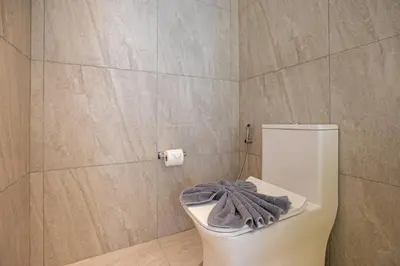 a bathroom with a toilet with a towel on it at Sapphire Bay Luxury Condominiums Patong, 811 in Patong Beach