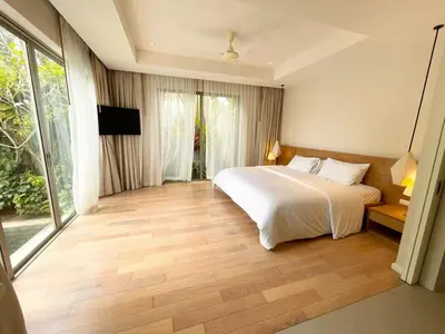 a bedroom with a white bed and a large window at V164 Famous 5 Trichada Resort 4-Bedroom in Thalang