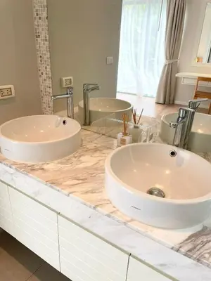 a bathroom with two sinks and two mirrors at V164 Famous 5 Trichada Resort 4-Bedroom in Thalang
