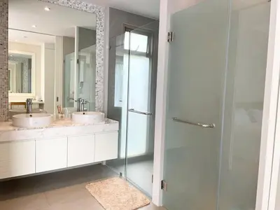 a bathroom with two sinks and a glass shower at V164 Famous 5 Trichada Resort 4-Bedroom in Thalang