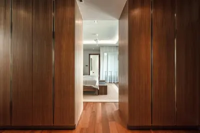 a hallway with wooden cabinets and a bed in a room at V165 Famous Anchan Flora 4 BR in Thalang