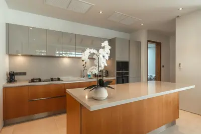 a kitchen with a counter with a vase of flowers at V165 Famous Anchan Flora 4 BR in Thalang