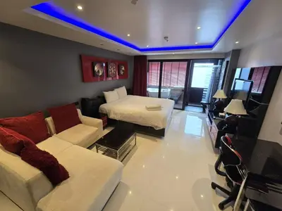 a living room with a couch and a bed at Absolute Bangla Jacuzzi Suites Condo in Patong Beach