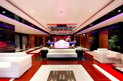 a large lobby with white furniture and a stage at Absolute Bangla Jacuzzi Suites Condo in Patong Beach