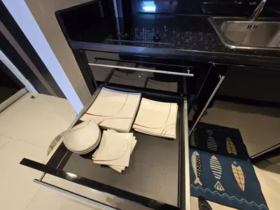 a kitchen with a counter top with books on it at Absolute Bangla Jacuzzi Suites Condo in Patong Beach