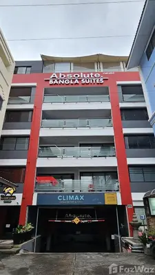 a building with a sign on the side of it at Absolute Bangla Jacuzzi Suites Condo in Patong Beach