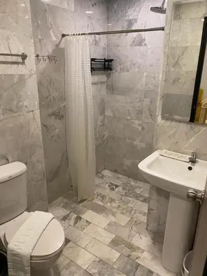 a bathroom with a white toilet and a sink at Maikhao Beach Condominium in Mai Khao Beach