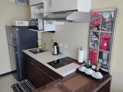 a small kitchen with a sink and a refrigerator at Maikhao Beach Condominium in Mai Khao Beach