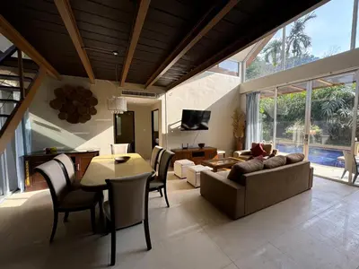 a living room with a couch and a table at Nai Thon villa with pool, garden, rooftop terrace in Nai Thon Beach