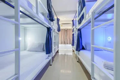 a room with two bunk beds in a hospital at The Little Nest Phuket in Phuket Town