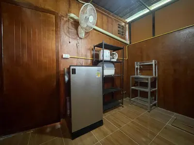a kitchen with a refrigerator and a fan at Lamai home 4 in Ko Yao Noi