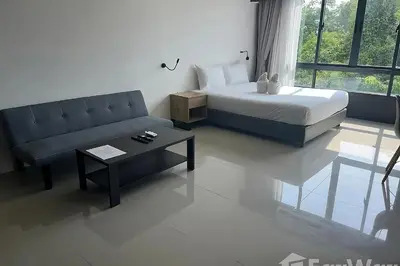 a living room with a bed and a couch at Utopia Guesthouse in Phuket Town