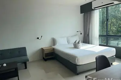 a bedroom with a white bed and a window at Utopia Guesthouse in Phuket Town