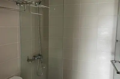 a bathroom with a shower and a toilet at Utopia Guesthouse in Phuket Town