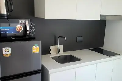 a kitchen with a sink and a microwave at Utopia Guesthouse in Phuket Town