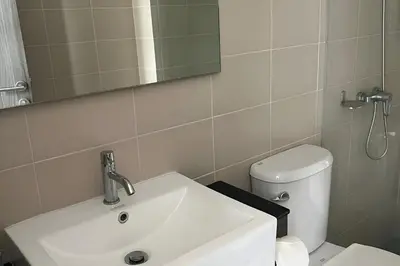 a bathroom with a sink and a toilet and a mirror at Utopia Guesthouse in Phuket Town