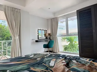 a bedroom with a bed and a large window at Peaceful Patong Penthouse in Patong Beach