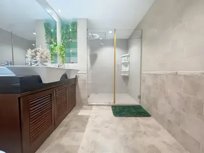 a bathroom with a sink and a shower at Peaceful Patong Penthouse in Patong Beach
