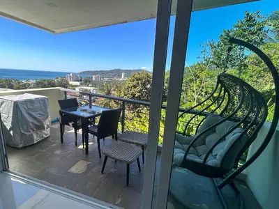 a view from the balcony of a house with a table and chairs at Karon Butterfly Condominium Brandnew, spacious 65m2 full seaview apartment, large pool, 300m from Karon beach in Karon Beach
