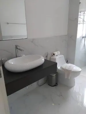 a white bathroom with a sink and a toilet at Karon Butterfly Condominium Brandnew, spacious 65m2 full seaview apartment, large pool, 300m from Karon beach in Karon Beach