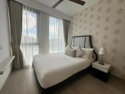 a bedroom with a bed and a large window at Lake view apartment in Laguna in Bang Tao Beach