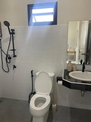 a bathroom with a toilet and a sink at Detached house Rawai beach in Ban Saiyuan (1)