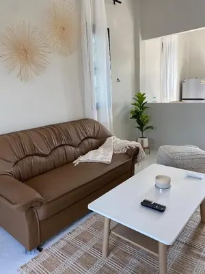 a living room with a couch and a coffee table at Detached house Rawai beach in Ban Saiyuan (1)