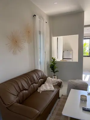 a living room with a brown leather couch at Detached house Rawai beach in Ban Saiyuan (1)