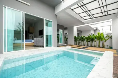 a swimming pool in a house with a bedroom at Laguna Beach Villa Phuket 207byน้องมังคุด in Ban Pak Lak