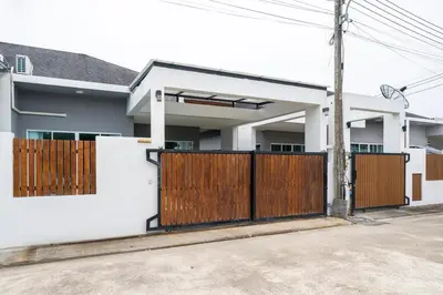 a house with a wooden gate in front of it at Laguna Beach Villa Phuket 207byน้องมังคุด in Ban Pak Lak