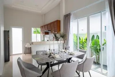 a dining room with a glass table and chairs at Laguna Beach Villa Phuket 207byน้องมังคุด in Ban Pak Lak