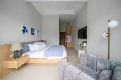 a bedroom with a bed and a couch at Laguna Beach Villa Phuket 207byน้องมังคุด in Ban Pak Lak